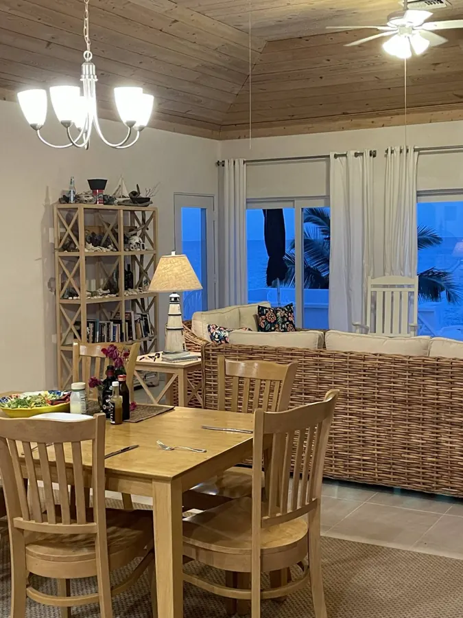 Dinner laid on the dining table in the evening, ocean out the sliding doors