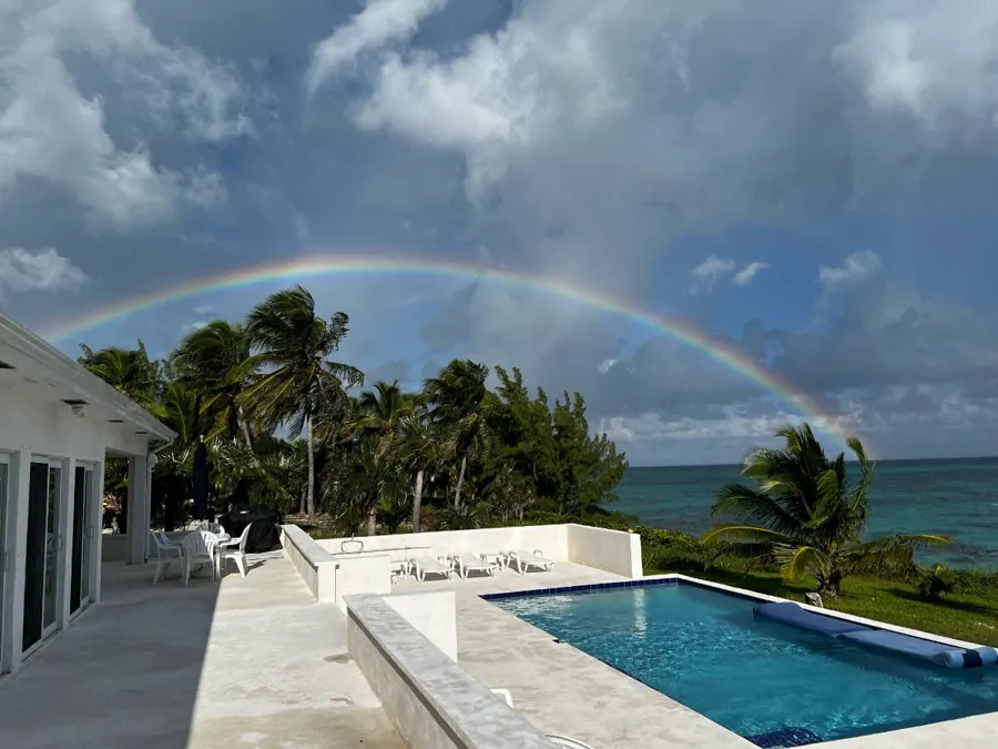 A rainbow over the pool and the ocean after a passing shower
