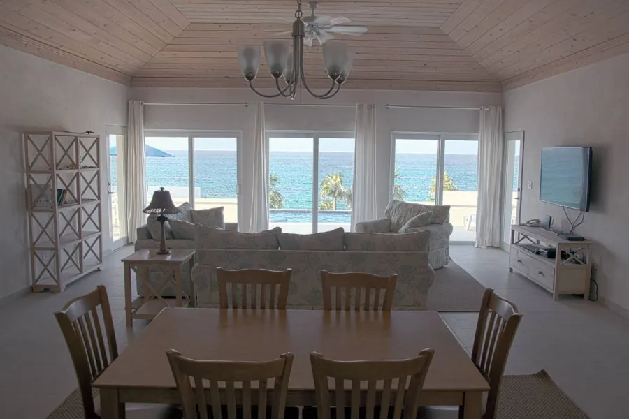 Living and dining rooms with the ocean through the sliding doors
