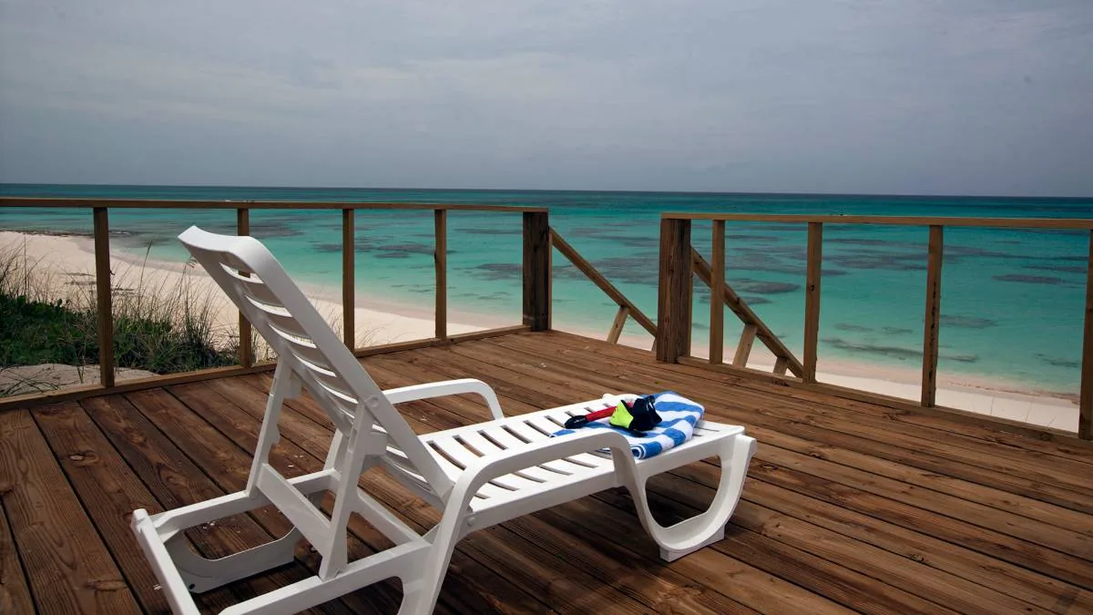 The beach deck above the sand, snorkel gear on the lounger