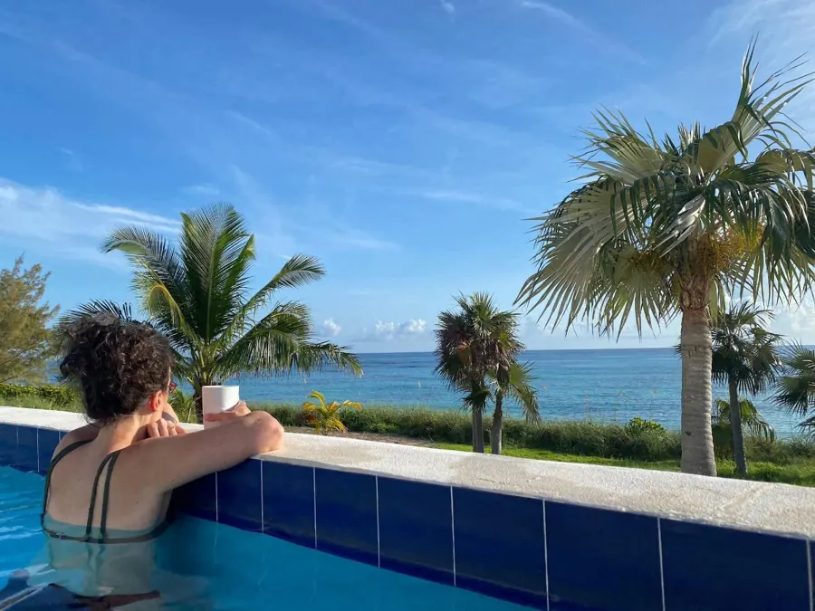 Coffee in the pool, looking out at the palms and the ocean